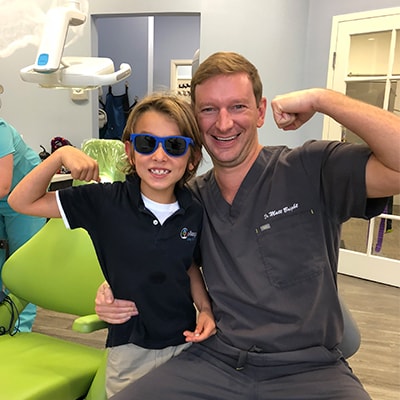 Dr. Bright posing with one of our Jacksonville patients