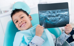 boy holding up X-ray showing benefits of cavity nutrition counseling