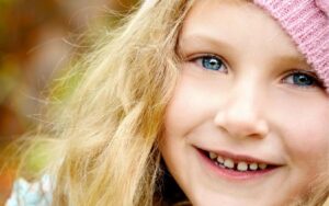 young child with toothy smile