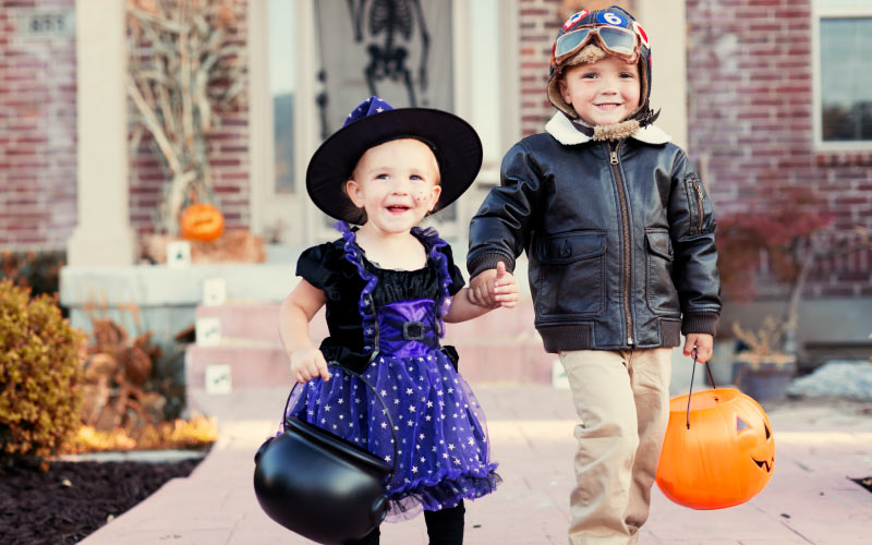 young girl and boy in costumes for halloween