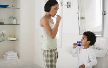mother and child brushing teeth